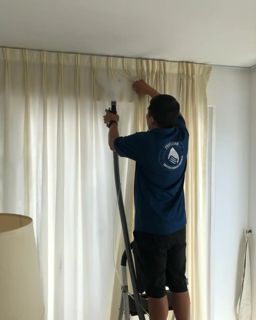 Proclean technician steam cleaning curtains on the rail in a Hong Kong home