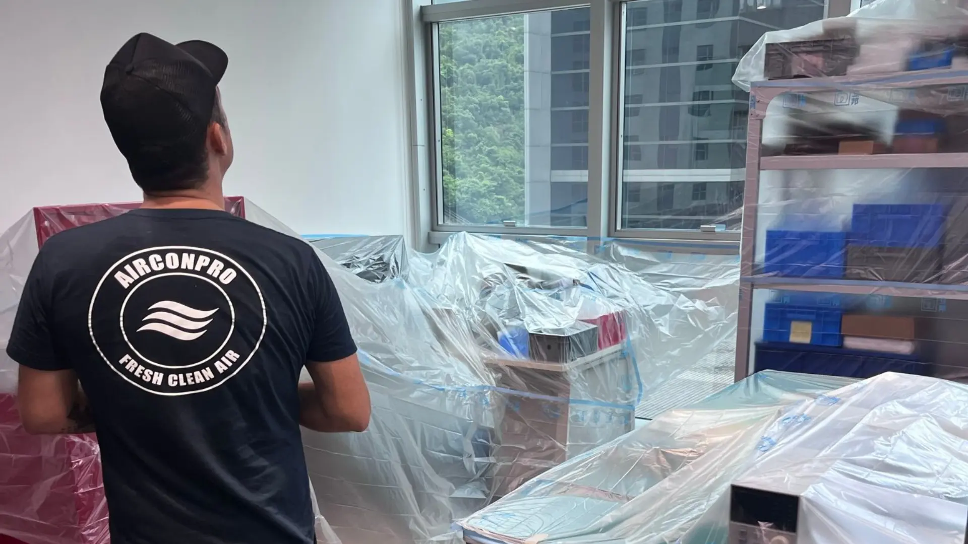 Fan Coil Unit and Duct Cleaning in Hong Kong: Better Air, Lower Bills 3 AirconPro technician preparing a protected work area before cleaning fan coil units